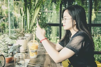 Photo of Woman Using Her Mobile Phone