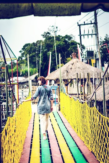 Photo Of Woman Walking On A Bridge