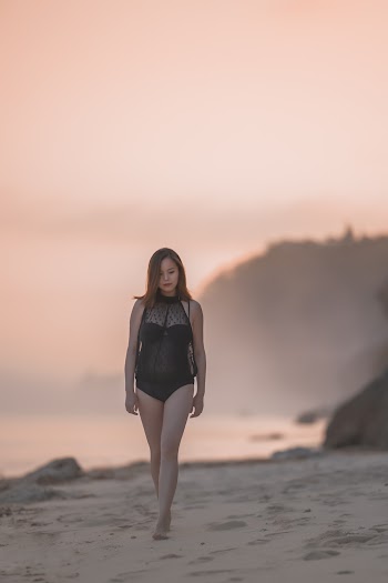 Photo of Woman Walking on Beach
