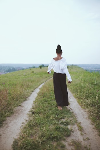 Photo of Woman Walking On Grass