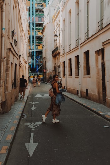 Photo Of Woman Walking On Pavement