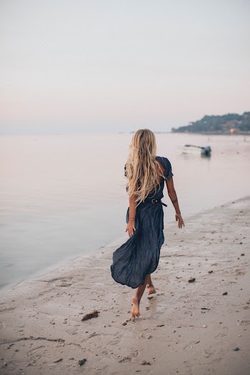 Photo of Woman Walking On Seashore