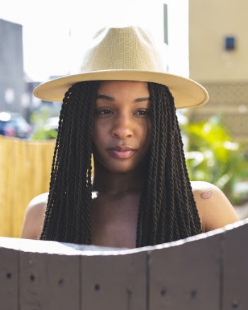 Photo of Woman Wearing Beige Fedora Hat