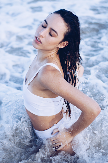 Photo of Woman Wearing Bikini Standing on Body of Water