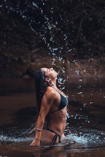 Photo of Woman Wearing Bikini While Standing on Body of Water