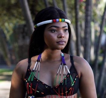 Photo of Woman Wearing Black Brassiere and Headdress