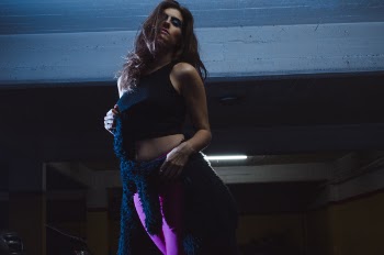 Photo of Woman Wearing Black Crop Top and Purple Leggings