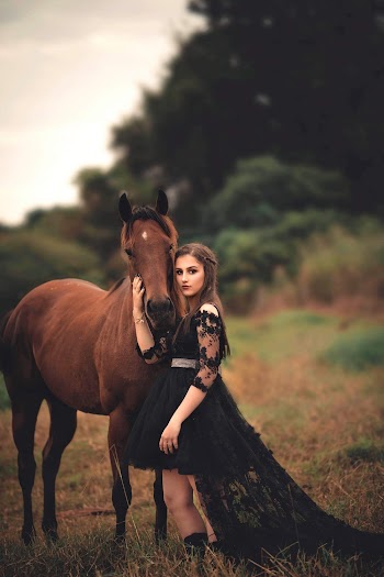 Photo of Woman Wearing Black Dress Beside Horse