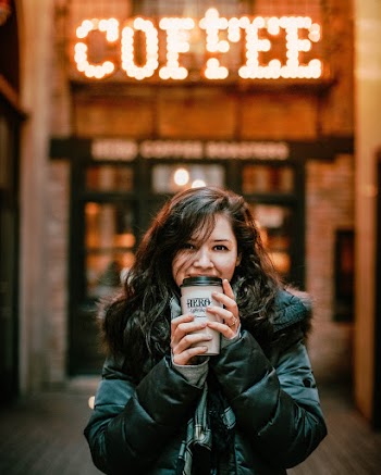 Photo of Woman Wearing Black Leather Jacket Holding A Tumbler