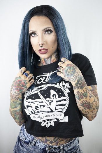 Photo of Woman Wearing Black Shirt With Tattoos