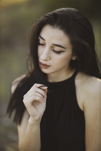 Photo Of Woman Wearing Black Sleeveless Top