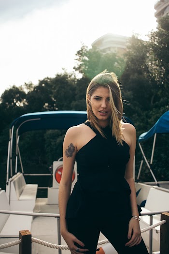 Photo of Woman Wearing Black Top Standing Near Boat