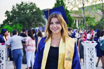 Photo of Woman Wearing Blue Graduation Dress