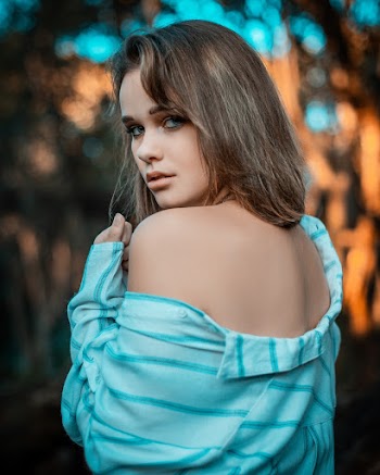 Photo of Woman Wearing Blue Striped Shirt