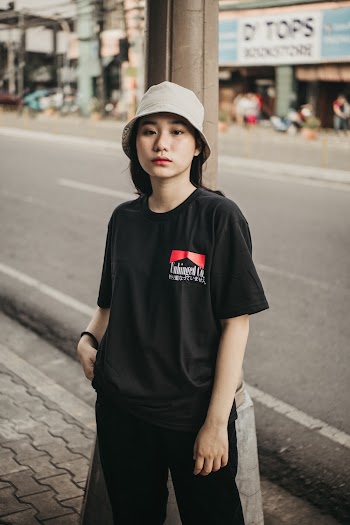 Photo of Woman Wearing Bucket Hat and Black Shirt