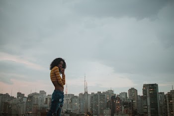 Photo of Woman Wearing Crop Top and Ripped Jeans