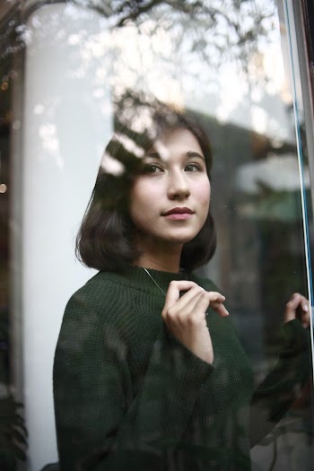 Photo of Woman Wearing Dark Green Sweater