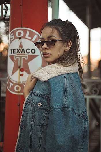 Photo of Woman Wearing Denim Jacket and Sunglasses