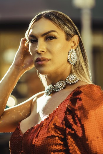 Photo of Woman Wearing Diamond Earring and Necklace