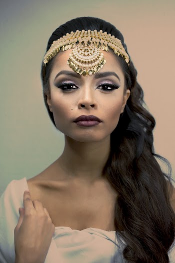 Photo of Woman Wearing Gold Headdress