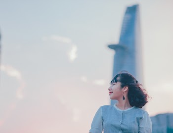 Photo of Woman Wearing Gray Button-up Top