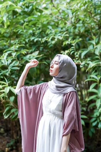 Photo of Woman Wearing Gray Hijab Posing Near Trees