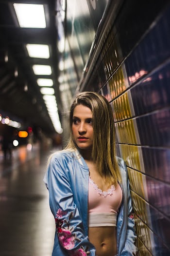 Photo of Woman Wearing Jacket Near Tiled Wall