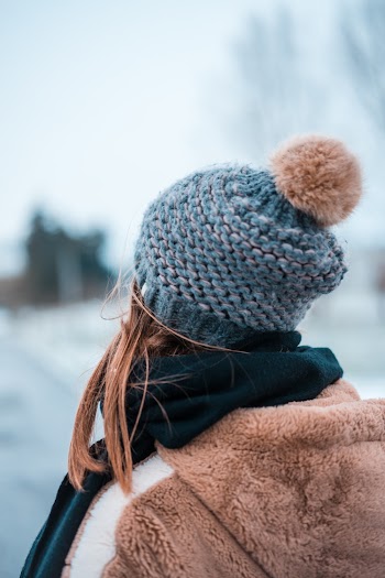 Photo of Woman Wearing Knitted Beanie