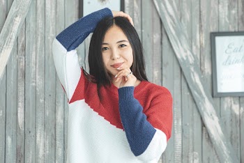 Photo of Woman Wearing Knitted Sweater