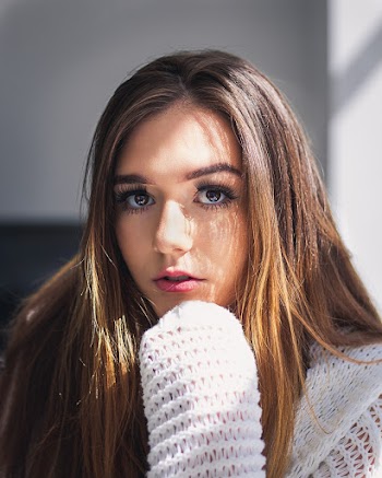 Photo of Woman Wearing Knitted Sweater