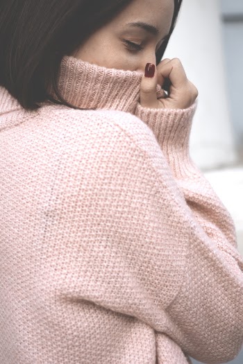 Photo of Woman Wearing Knitted Sweater