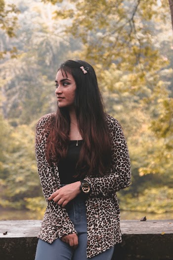 Photo of Woman Wearing Leopard Pattern Jacket While Looking To Her Right