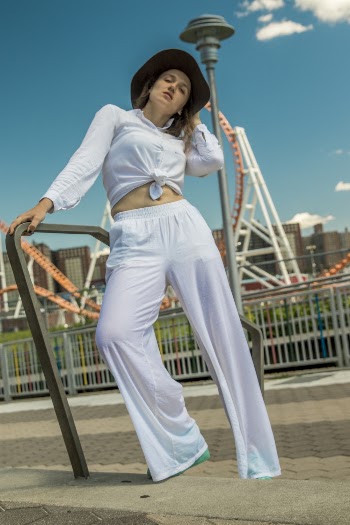Photo of Woman Wearing Long-sleeved Shirt and White Pants