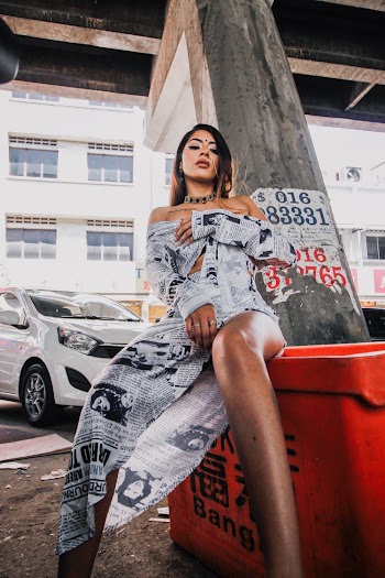 Photo Of Woman Wearing Newspaper dress