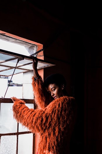 Photo Of Woman Wearing Orange Coat