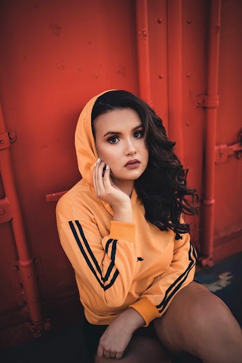 Photo of Woman Wearing Orange Hoodie