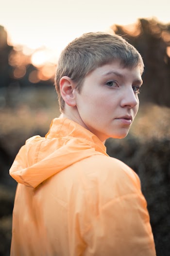 Photo of Woman Wearing Orange Jacket