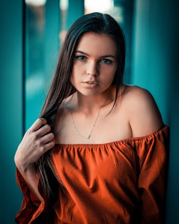 Photo of Woman Wearing Orange Off-shoulder Blouse