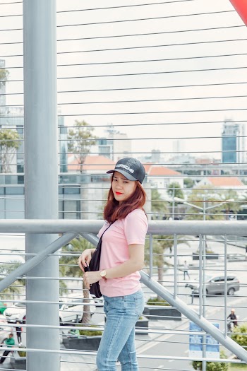 Photo of Woman Wearing Pink Shirt Standing Beside Railing