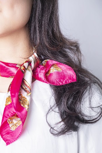 Photo of Woman Wearing Pink Silk Bandana