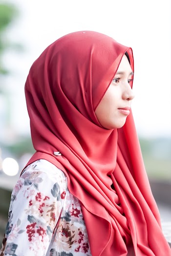 Photo of Woman Wearing Red Hijab and Floral Top