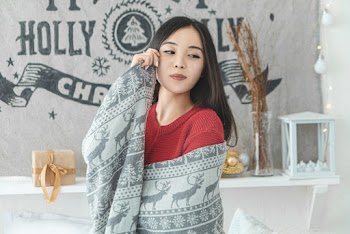 Photo of Woman Wearing Red Knitted Sweater Against Christmas Background