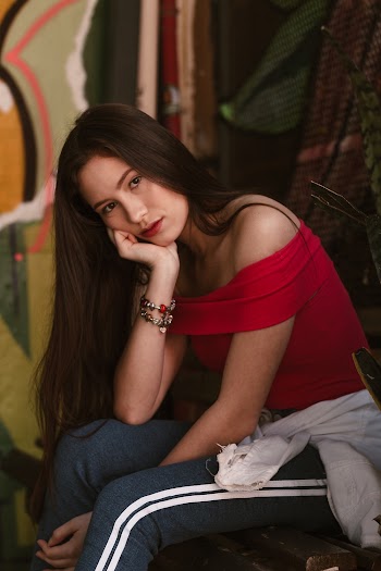 Photo of Woman Wearing Red Off Shoulder Top