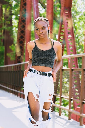 Photo of Woman Wearing Ripped Jeans