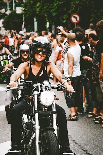 Photo of Woman Wearing Shirt While Riding Motorcycle