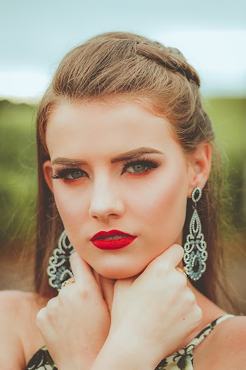 Photo of Woman Wearing Silver-colored Earrings