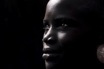 photo of woman wearing silver-colored hoop earring