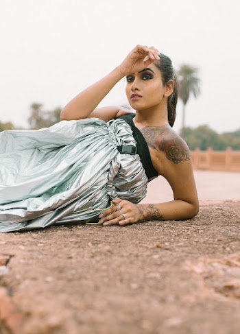 Photo of Woman Wearing Silver Dress