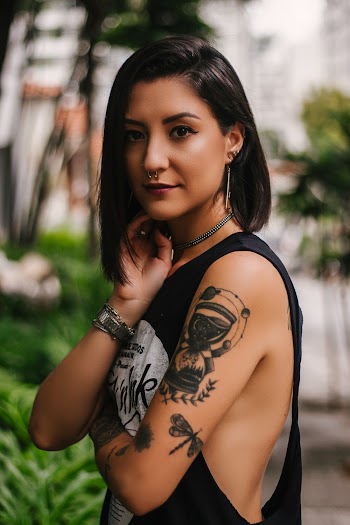 Photo of Woman Wearing Sleeveless Top With Tattoos and Piercings