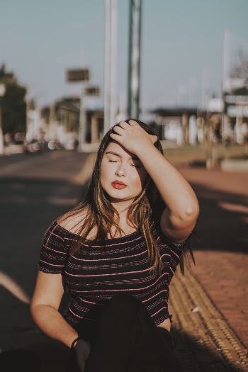 Photo Of Woman Wearing Striped Shirt Walking On Street